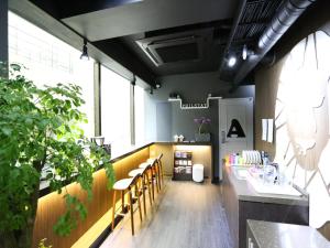 a restaurant with a row of chairs and a counter at Philstay Myeongdong Boutique Female in Seoul