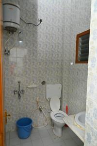 a bathroom with a shower with a toilet and a sink at TN27Calling Villa in Yercaud +10 photos