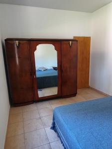a bedroom with a bed and a cabinet with a mirror at Casa Quinta San Pedro in San Pedro +20 photos