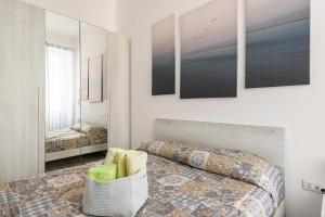 a bedroom with a bed and a mirror at Leo Holiday Homes in Deiva Marina