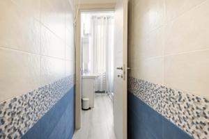 a bathroom with blue and white tiles on the walls at Leo Holiday Homes in Deiva Marina +26 photos