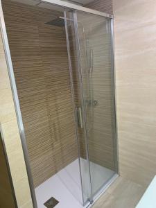 a shower in a bathroom with a glass door at CALARREONA - Apartamento a 100 metros de la playa in Águilas +18 photos