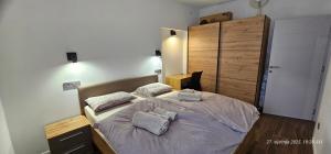 a bedroom with a bed with two pillows on it at Apartman Ruža in Brdovec