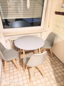 a table and chairs in a room with a window at FMI 66 Next to Airport in Mörfelden-Walldorf