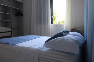 a bed sitting in a bedroom with a window at Apartment in Ondina, Carnival Circuit, Luxury in Salvador