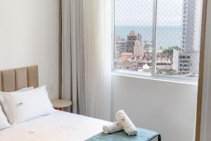 En eller flere senge i et værelse på Achei Itapema • Elegante ap c/ vista do mar 2dorm + 40 billeder