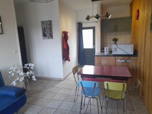 a kitchen with a table and chairs in a room at gite de l'auberge in Olby
