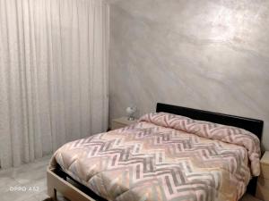 a bedroom with a bed in a room with a wall at Perla di mare in Montesilvano