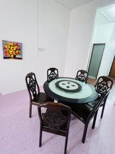 a dining room table and chairs in a room at Homestay Kota Bharu in Kota Bharu