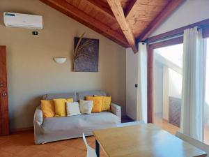 a living room with a couch with yellow pillows at Sal&Love apt in Porto Antigo in Santa Maria +155 photos