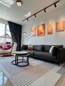 a living room with a couch and a table at SURIA HomeStay Kuala Terengganu City Center, 8 pax, 150M to KTCC Mall in Kuala Terengganu