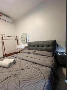 a large bed in a room with a mirror at SURIA HomeStay Kuala Terengganu City Center, 8 pax, 150M to KTCC Mall in Kuala Terengganu