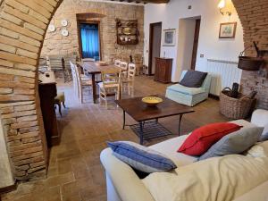 a living room with a couch and a table at Casa Vacanze Le Corone in Otricoli