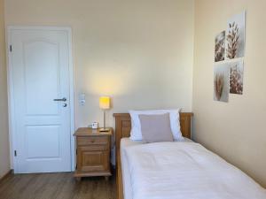 Postel nebo postele na pokoji v ubytování Hotel-Pension Hommen