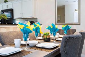 a dining room table with plates and wine glasses at Three Bedrooms Townhome 3012 in Kissimmee