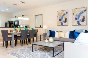 a living room with a couch and a table at Three Bedrooms Townhome 3012 in Kissimmee