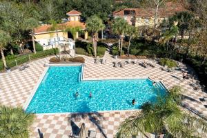 an overhead view of a swimming pool with people in it at Three Bedrooms Townhome 3012 in Kissimmee