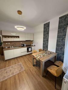 a kitchen and dining room with a table and chairs at Bellissima Residence in Valea lui Mihai