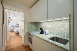 a kitchen with a sink and a counter top at Ocean View Retreat 1 in São Roque +22 photos