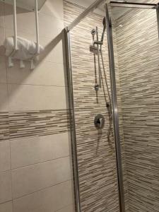 a shower with a glass door in a bathroom at Casa Miguel in Molfetta