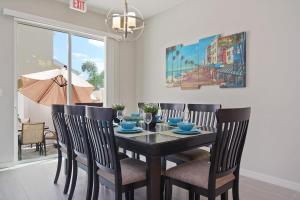 a dining room with a black table and chairs at Four Bedroom w/ GameRoom 5152A in Kissimmee