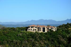 a house on top of a hill with mountains in the background at Villa Seaview in Knysna