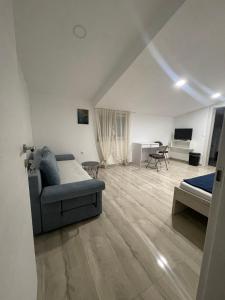 a living room with a couch and a bed and a desk at Vila White Pearl in Vir