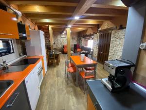 a kitchen and living room with a table and chairs at Casa Rural María y Daniel in Castrillo de Duero +15 photos