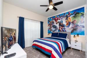 a bedroom with a superhero mural on the wall at Stunning 5 Bd w/ Pool Close to Disney 2905 in Kissimmee