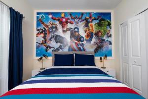 a bedroom with a avengers mural on the wall at Stunning 5 Bd w/ Pool Close to Disney 2905 in Kissimmee +74 photos