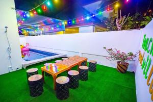 a patio with a table and stools and a pool at Soi 15 Thappraya Pool villa- 5km to Jomtien beach in Pattaya Central +58 photos