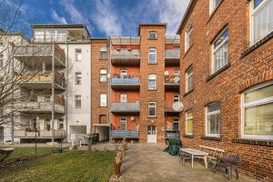 an apartment building with a courtyard in front of it at Flower Love in Eilenburg