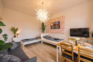 a living room with a couch and a table at Flower Love in Eilenburg
