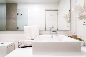 a white bathroom with a sink and a bath tub at Casa Flor Cabo Your Private Oasis in Cabo San Lucas +45 photos