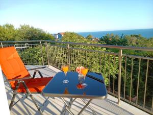 a blue table with two glasses on a balcony at Villa Black Sea in Balchik