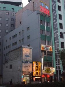a building with a sign on the side of it at Eco Hotel Nagoya in Nagoya