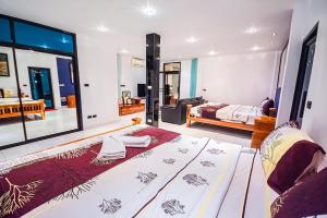 a bedroom with two beds and a living room at Soi 15 Thappraya Pool villa- 5km to Jomtien beach in Pattaya Central