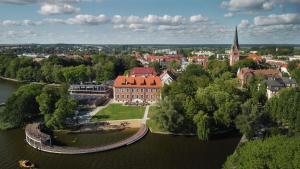 an aerial view of a city with a river and a church at Apartament Wendigo - butikowy, 2-poziomowy, blisko jeziora in Szczecinek