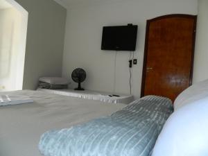 Cama ou camas em um quarto em Pousada Central de Cabreuva