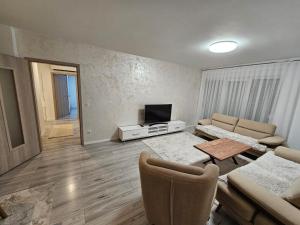 a living room with a couch and a television at Matin apartment in Ferizaj