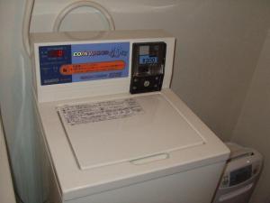 an electronic device sitting on top of a washing machine at Eco Hotel Nagoya in Nagoya