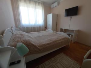a hospital room with a bed and a television at CsászárLak Vendégház in Tarcal