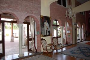 a room with chairs and tables in a building at Castello Scandeluzza in Rome +2 photos