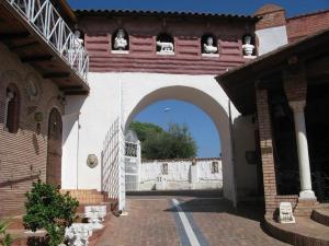 an archway in a building with a white fence at Castello Scandeluzza in Rome