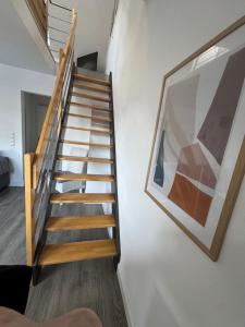 a staircase in a house with a picture on the wall at City Apartments am Rhein in Bonn +51 photos
