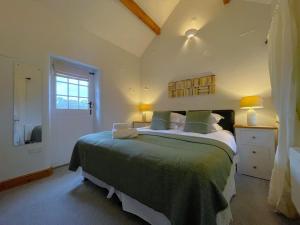 a bedroom with a large bed in a room at Deer Close Cottage in Keswick