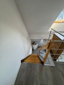 a staircase in a room with white walls and wooden floors at City Apartments am Rhein in Bonn
