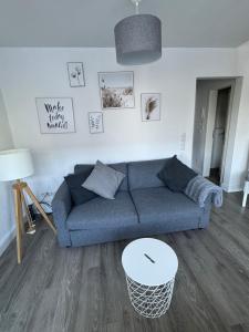 a living room with a blue couch and a table at City Apartments am Rhein in Bonn