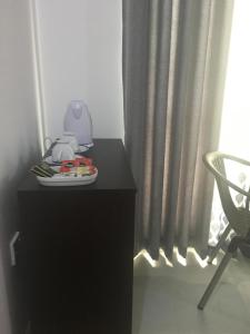 a black dresser with a blender on it next to a window at Air Ray Homestay in Negombo