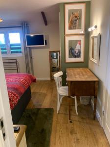 a bedroom with a desk and a bed and a table at Field End in Liskeard +43 photos
